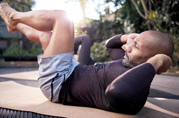 Man doing crunches in garden