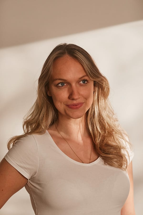 Elle Robertson smiling in a white tshirt
