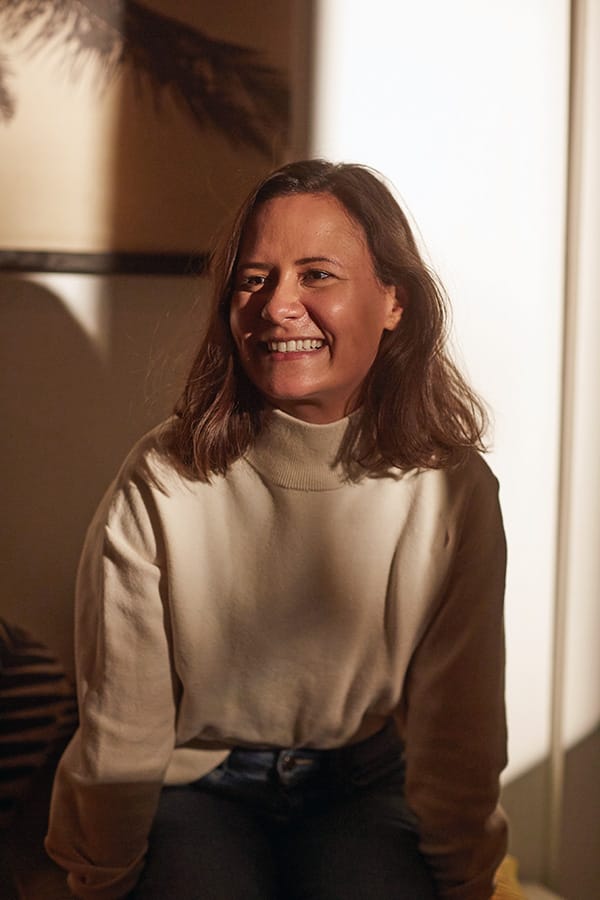 Erica Delaney smiling in a white jumper