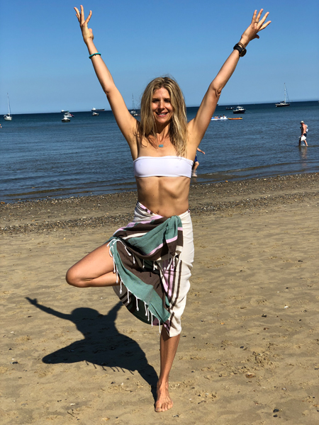 Woman in bikini and sarong on beach