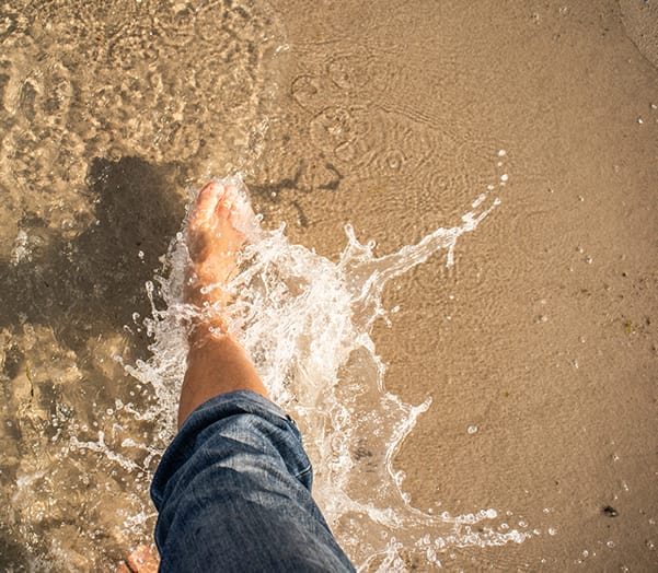 Feet in water beach