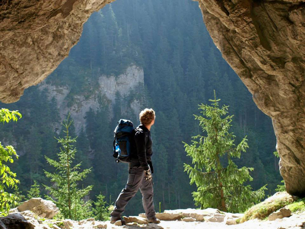 Man walking in nature with backpack