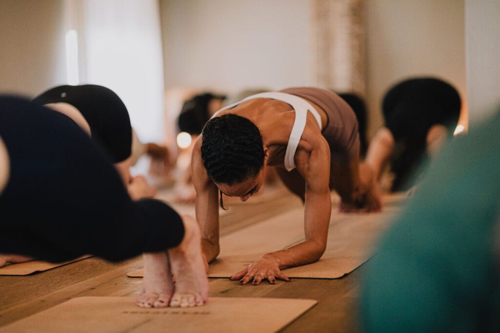 Hot Pilates class with people in plank pose