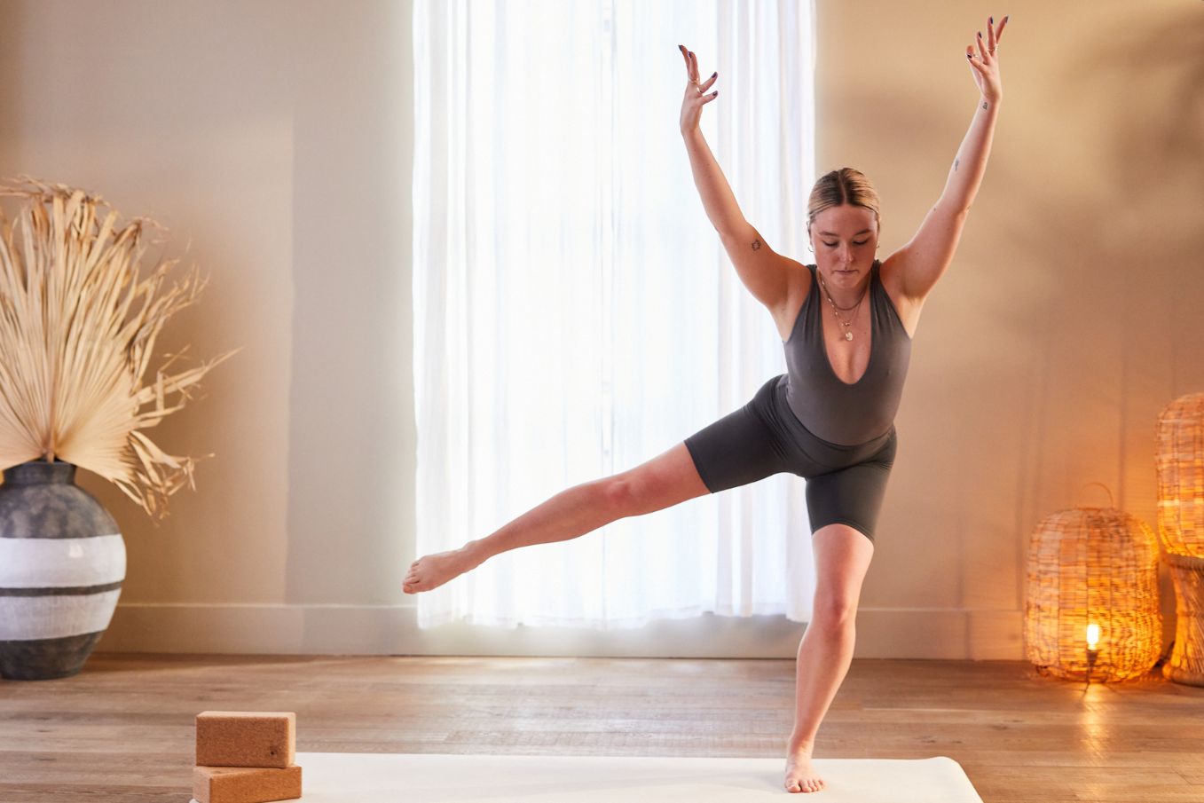 Pilates teacher balancing on one leg